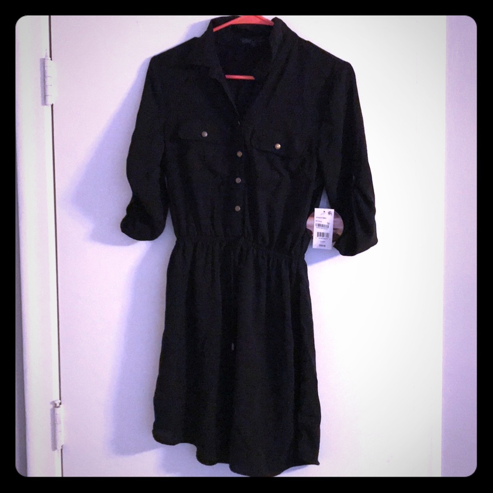Short black half button up dress.